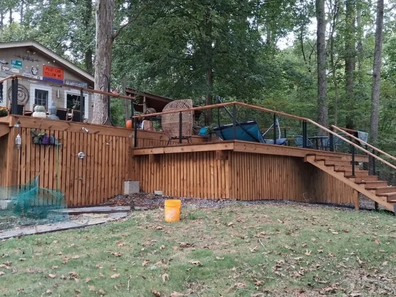 Raised backyard deck with stairs and railings